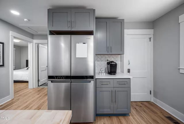 1402 Robinhood Rd, Durham, NC 27701 - kitchen featuring freestanding refrigerator, gray cabinetry, visible vents, light wood-style floors, and light countertops