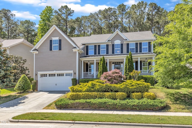 view of front of house with a porch, a garage, a shingled roof, and concrete driveway