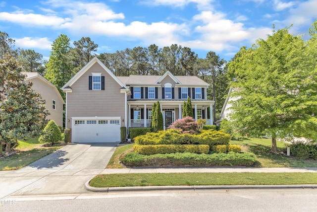 view of front of property featuring a porch, driveway, and a garage