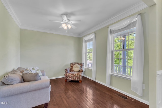 sitting room featuring wood-type flooring, ceiling fan, visible vents, and crown molding