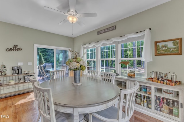 dining area with a ceiling fan and wood finished floors