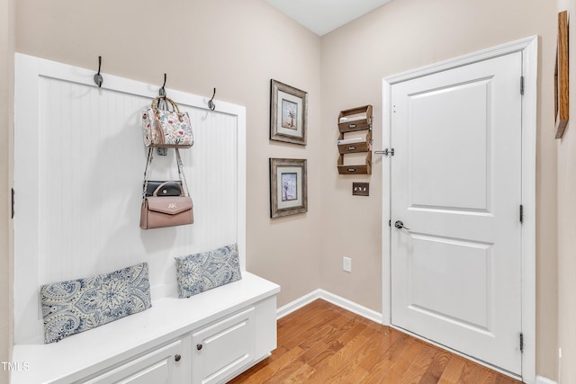 mudroom with light wood-style floors and baseboards