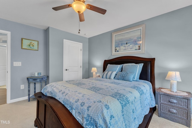 bedroom with light colored carpet, a ceiling fan, and baseboards