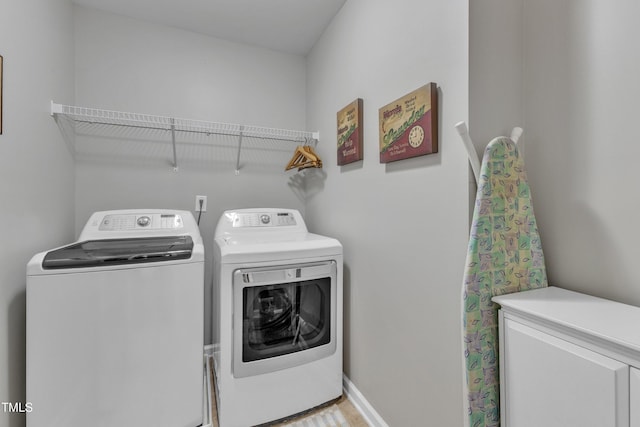 laundry area featuring washer and dryer, laundry area, and baseboards