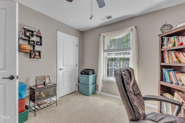 carpeted home office with ceiling fan, visible vents, and baseboards