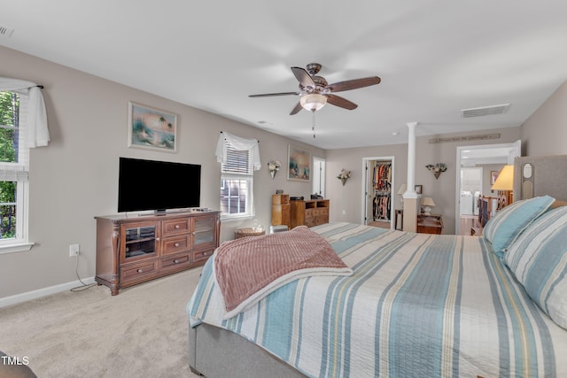 bedroom with baseboards, visible vents, multiple windows, and a spacious closet
