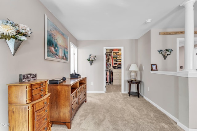 interior space featuring baseboards and light colored carpet