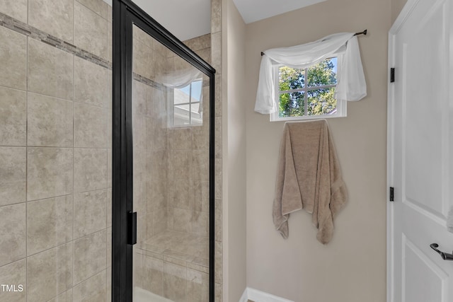 full bath featuring baseboards and a shower stall