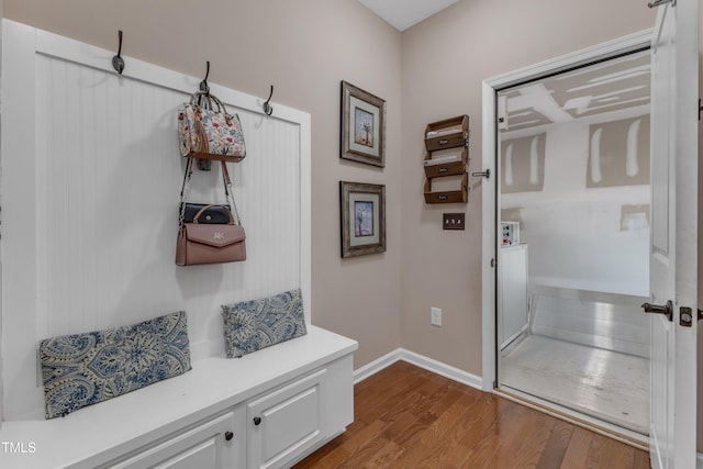 mudroom featuring baseboards and dark wood finished floors