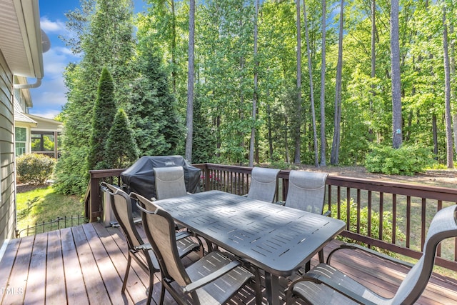 wooden terrace featuring grilling area and outdoor dining area