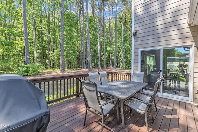 wooden deck featuring area for grilling and outdoor dining space