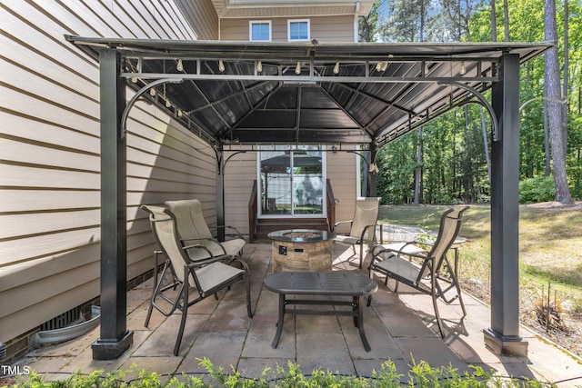 view of patio / terrace featuring a gazebo and an outdoor fire pit