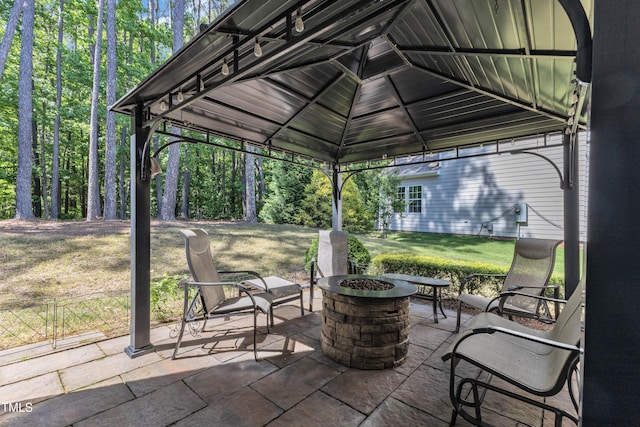 view of patio featuring a gazebo and an outdoor fire pit