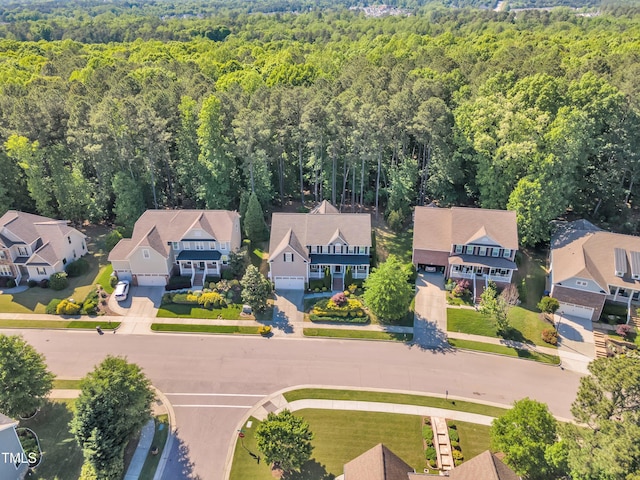 birds eye view of property featuring a view of trees and a residential view