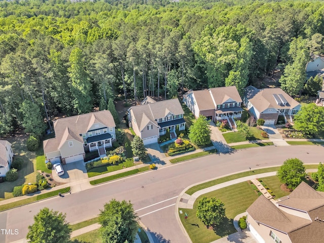 drone / aerial view with a residential view and a forest view