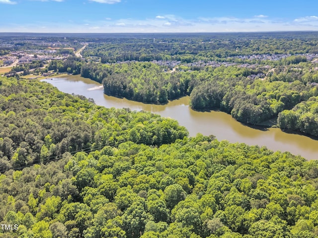 birds eye view of property with a water view and a forest view