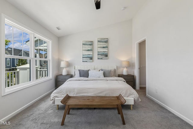 carpeted bedroom featuring a ceiling fan, baseboards, visible vents, and vaulted ceiling