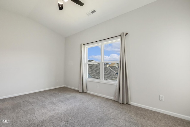 spare room featuring visible vents, a ceiling fan, lofted ceiling, baseboards, and carpet flooring