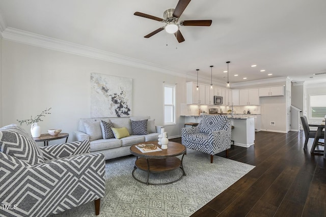 living room with crown molding, dark wood-style flooring, ceiling fan, recessed lighting, and a wealth of natural light