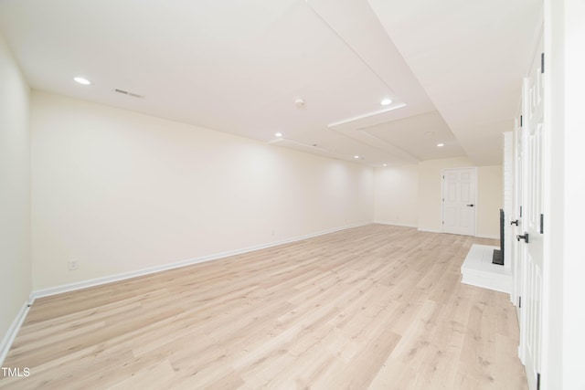 empty room with light wood-type flooring, recessed lighting, baseboards, and visible vents