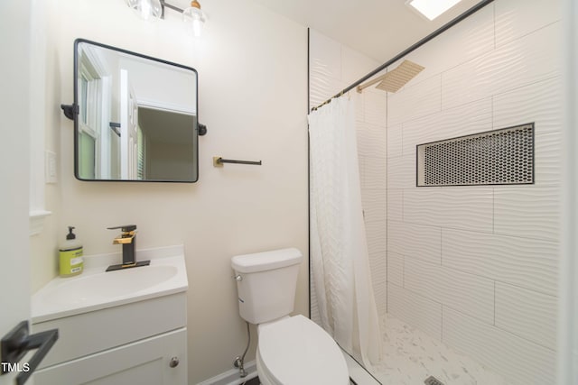 bathroom featuring vanity, toilet, and tiled shower