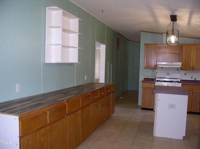 kitchen with under cabinet range hood, light tile patterned flooring, open shelves, and white gas range oven