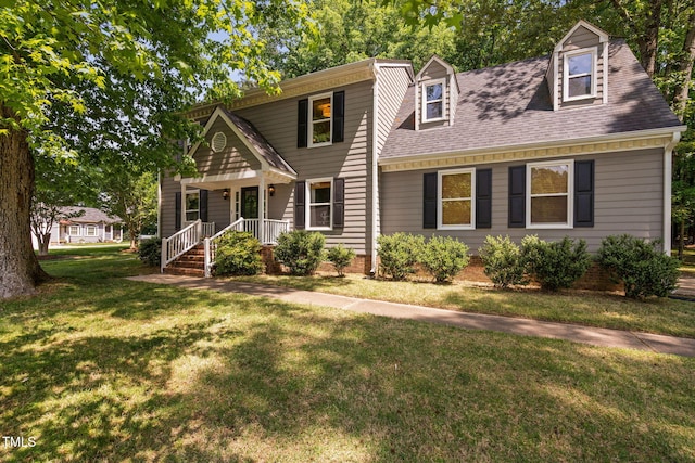 view of front facade featuring a shingled roof and a front lawn