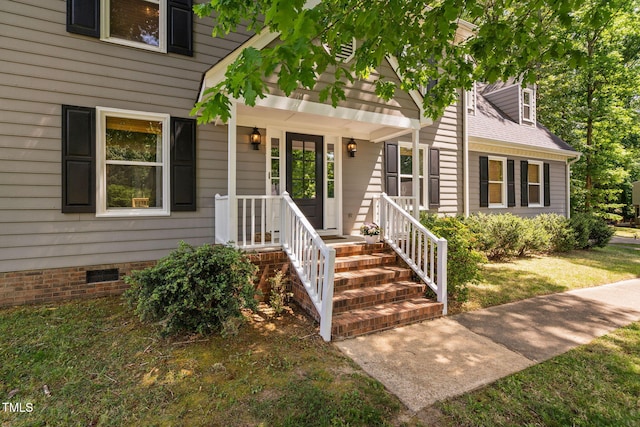 entrance to property featuring a yard and crawl space