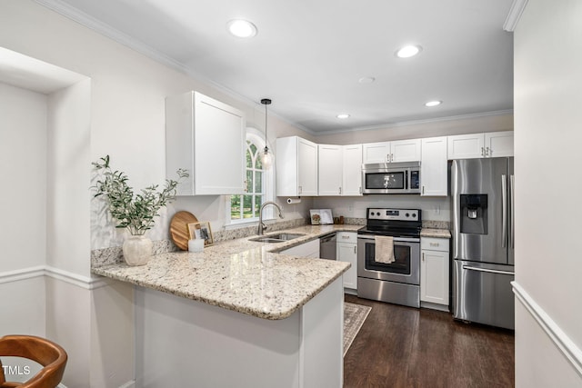 kitchen featuring ornamental molding, a peninsula, light stone countertops, a sink, and stainless steel appliances