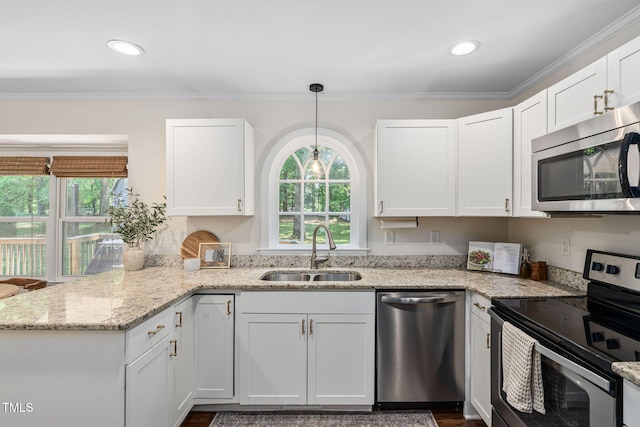 kitchen featuring a sink, white cabinets, a wealth of natural light, and stainless steel appliances
