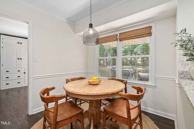 dining room with baseboards, dark wood finished floors, and ornamental molding