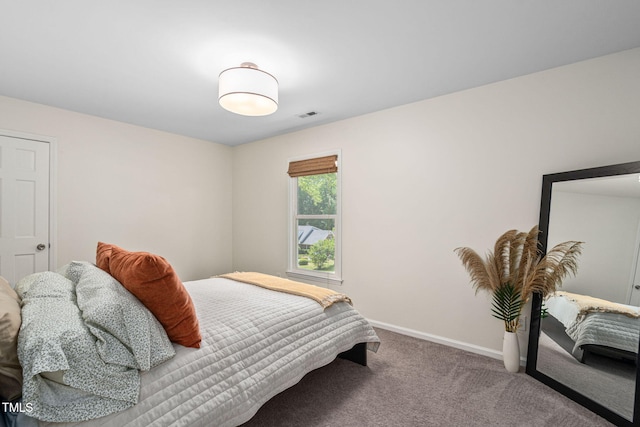 carpeted bedroom featuring visible vents and baseboards
