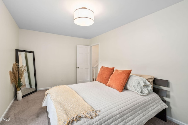 bedroom featuring baseboards and carpet flooring