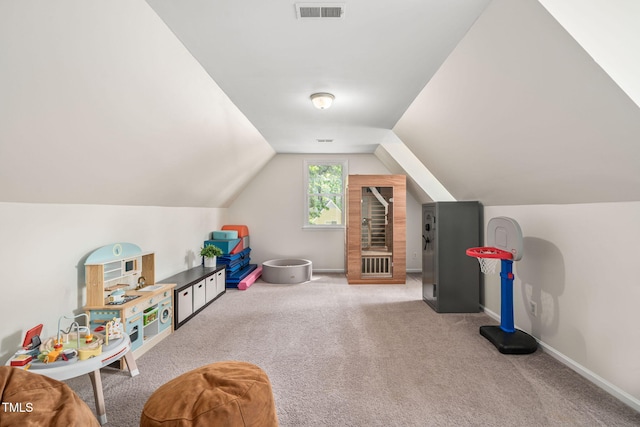 game room with carpet floors, baseboards, lofted ceiling, and visible vents