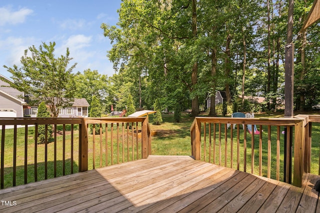 wooden deck featuring a lawn
