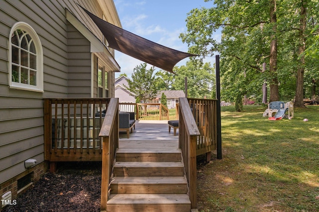 wooden terrace featuring a yard