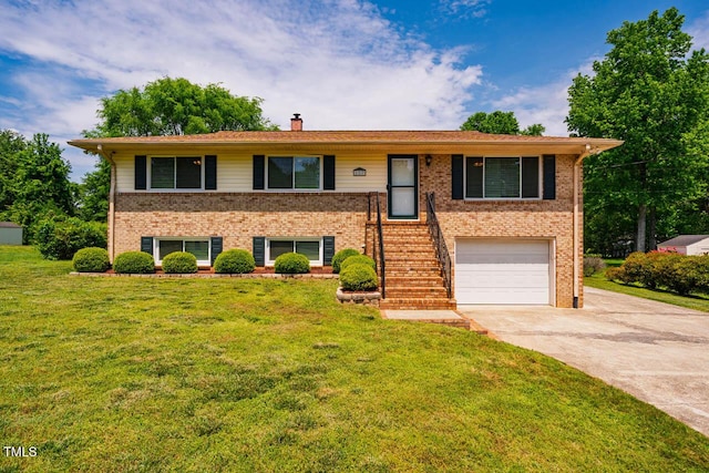 view of front of home with a garage, a front yard, a chimney, brick siding, and concrete driveway