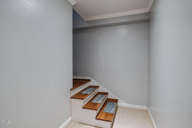 stairway featuring crown molding, baseboards, and tile patterned floors