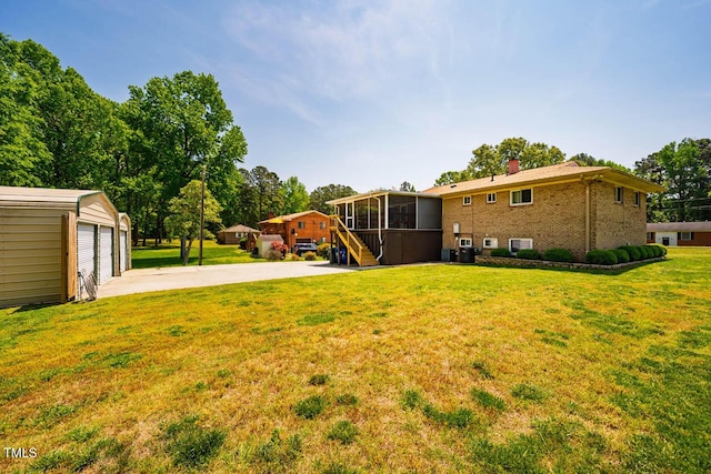 view of yard with an outdoor structure and a sunroom