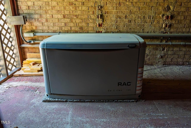 details featuring a power unit and brick siding