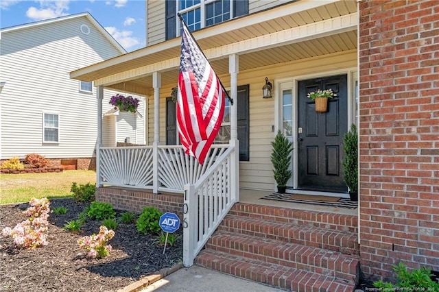 entrance to property featuring covered porch