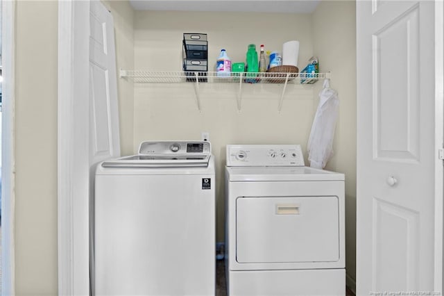 clothes washing area featuring laundry area and washing machine and clothes dryer