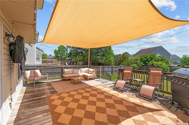 deck with a fenced backyard, an outdoor living space, and a grill