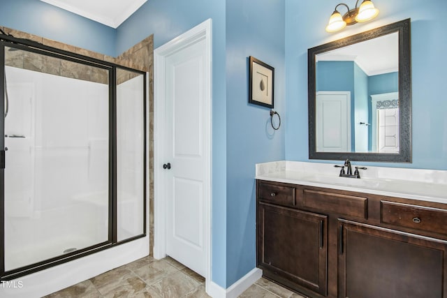 bathroom with crown molding, baseboards, a stall shower, and vanity