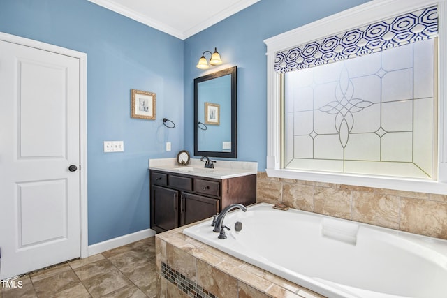 full bath with a garden tub, baseboards, crown molding, and vanity