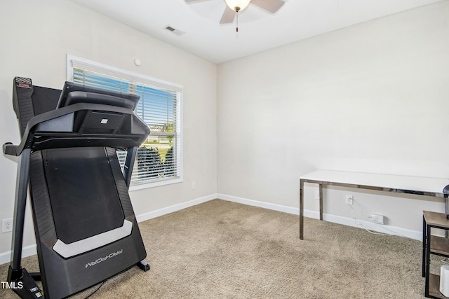 exercise room with baseboards, ceiling fan, carpet flooring, and visible vents
