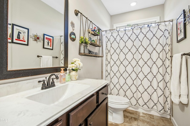 full bathroom featuring toilet, stone finish flooring, shower / bath combo, and vanity