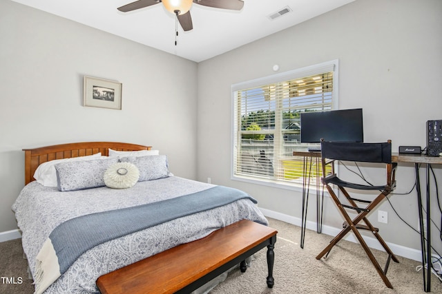 bedroom with baseboards, visible vents, and light colored carpet