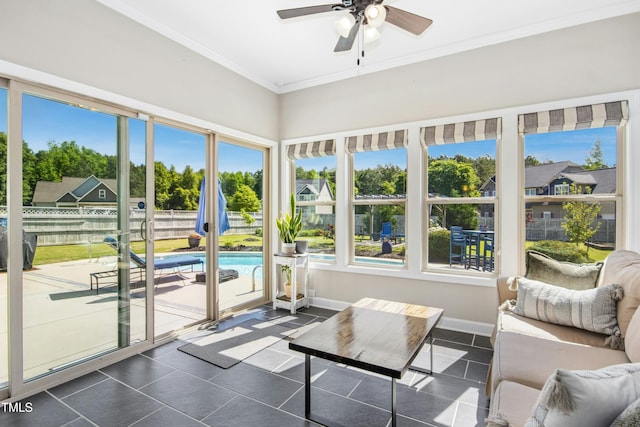sunroom with crown molding, tile patterned floors, and baseboards