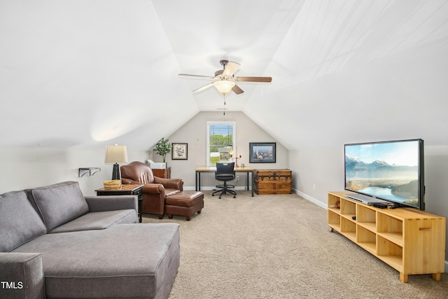 living room with ceiling fan, vaulted ceiling, light carpet, and baseboards